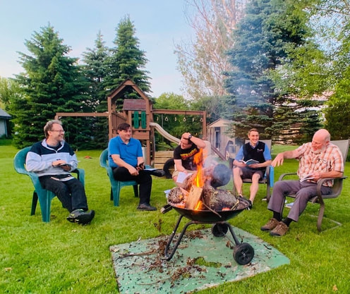 Members of JP2 Men’s Group engaging in conversation at their monthly meeting